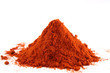 pile of ground paprika on white pile of ground paprika on white