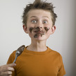 Boy eating chocolate messily