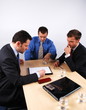 Three businessmen handling negotiations. Three businessmen handling negotiations.