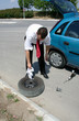 Photo: Businessman changing a tire Businessman changing a tire