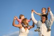 Smiling family on sky background