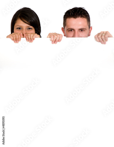 couple holding a white billboard
