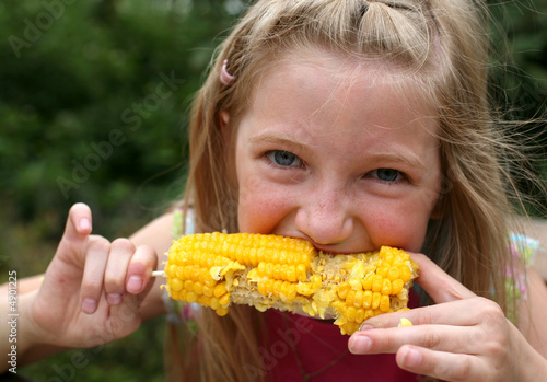 Photo: Young Girl Eating Corn Young Girl Eating Corn