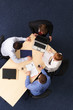 risky business strategy - four people meeting aided laptop