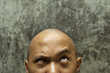 bald headed man with confuse expression