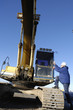 driver boarding large digger, bulldozer