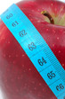 Red apple with measuring tape