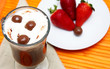 Cup of coffee with strawberries