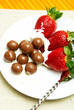 Strawberries and cream with chocolate balls