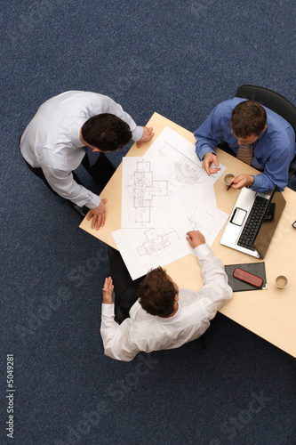 Photo: architects talking about blueprints architects talking about blueprints