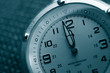 Closeup of a watch with both hands near 12
