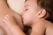 Little kid sleeping and breast-feed