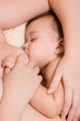 Little kid sleeping and breast-feed