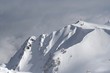 Peak with a snow and small weather station on it
