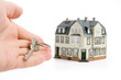 hand with key for house