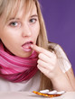 woman is taking a pill