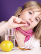 woman is taking a pill