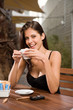 female sitting outside with a cup of coffee