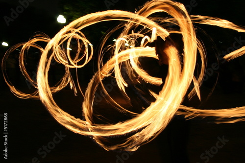 Photo: Poi dance performance with fire circular patterns Poi dance performance with fire circular patterns