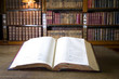 Photo en ligne au meilleur prix Open book in old library. Part of series