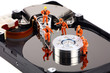 Miniature technicians work on hard drive