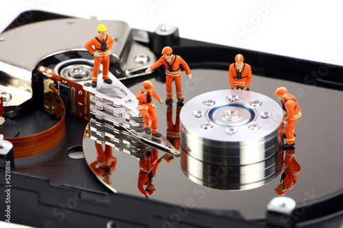 Foto: Miniature technicians work on hard drive Miniature technicians work on hard drive