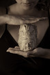 Faith - woman hands holding stone buddha figurine