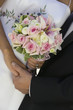 Bride and Groom holding hands and bouquet, close-up