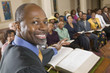 Preacher at altar with Bible preaching to Congregation, portrait, close up