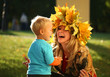 Young mother playing with little son in an autumn park. Young mother playing with little son in an autumn park.