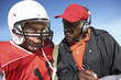 Photo: Coach talking to football player, close-up Coach talking to football player, close-up