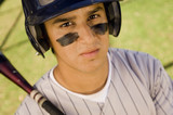 Photo: Baseball player with eye black, holding baseball bat on shoulder, portrait, elevated view Baseball player with eye black, holding baseball bat on shoulder, portrait, elevated view