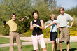 Four golfers standing on golf course