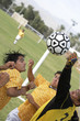 Soccer players competing for ball
