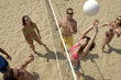 Group Playing Volleyball on Beach