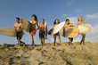 Group of Surfers Running Towards Waves