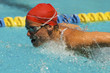 Photo: Woman swimming butterfly stroke, close-up Woman swimming butterfly stroke, close-up
