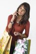 Woman with shopping bags and cellular phone Woman with shopping bags and cellular phone
