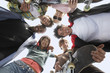 Foto: Young friends in huddle, view from below Young friends in huddle, view from below