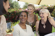 Photo: four mature elegant women chatting at garden party four mature elegant women chatting at garden party