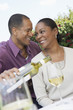 Photo: Mature man pouring wine for his elegant wife Mature man pouring wine for his elegant wife