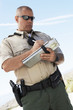 Foto: Police officer writing ticket, low angle view Police officer writing ticket, low angle view