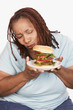 Overweight Woman holding hamburger
