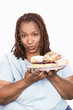 Overweight Woman holding Junk Food, portrait