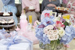 Table of gifts, flowers and cakes at baby shower