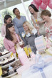 Woman showing off gift at baby shower