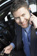 Businessman Using mobile Phone in car, smiling, half-length