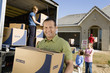 family unloading removal van in front of house