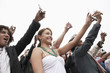 Crowd holding up cell phones, half length
