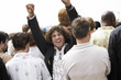 Cheering man facing the other way to rest of crowd